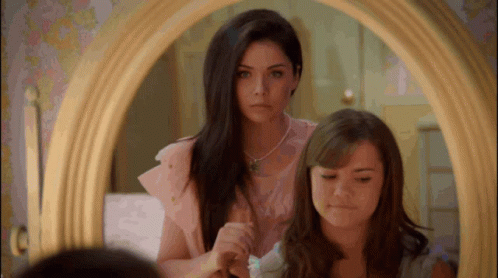 Girls Looking in Mirror and Brushing Hair