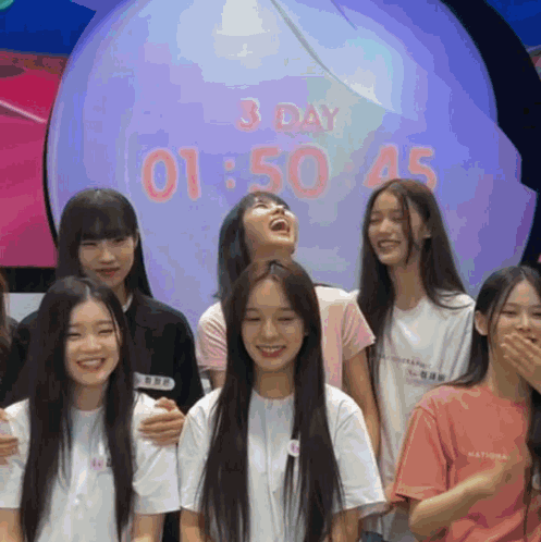 Girls Posing In Front Of 3 Day 1:50 Clock GIF