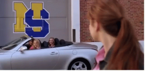 Girls Sitting In Silver Convertible Car In Front Of Building With Letter S GIF