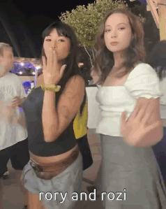 Girls Standing Together One Pointing