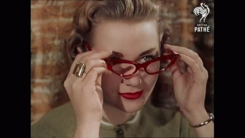 Lady Wearing Vintage Glasses GIF