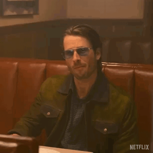 Glen Powell Cocky Wearing Dark Glasses GIF