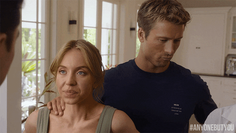 Glen Powell Sydney Sweeney Rubbing Shoulder GIF