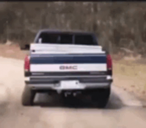 GMC Truck Driving On Dirt Road GIF