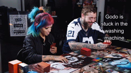Godo Is Stuck In The Washing Machine With A Man And Woman Playing A Board Game GIF