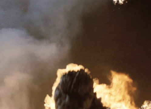 Godzilla Minus One Standing Up Behind Fire GIF