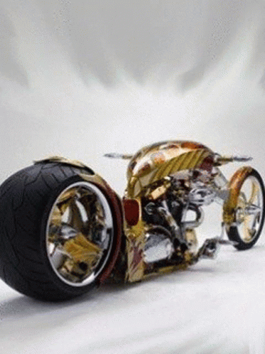 Gold And Silver Motorcycle With Large Tire GIF