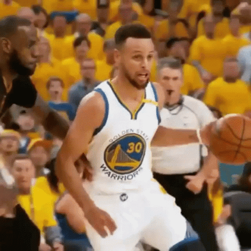 Golden State Warriors Basketball Player Stephen Curry Is Dribbling A Basketball During A Basketball Game . GIF