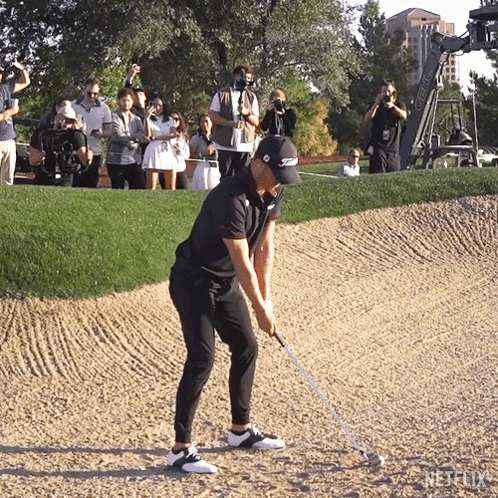 Golfer Hitting Golf Ball in Titleist Hat