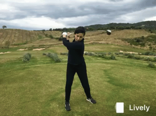 Golfer Swinging Club on Golf Course