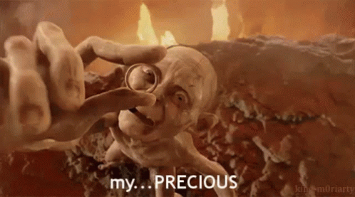Gollum From The Lord Of The Rings Is Holding A Ring In His Hand And Says `` My Precious '' . GIF