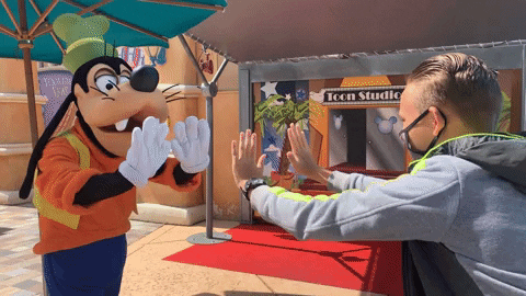 Goofy And Man High Five In Disneyland GIF
