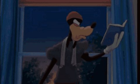 Goofy Is Reading A Book In Front Of A Window While Wearing A Towel Around His Neck . GIF