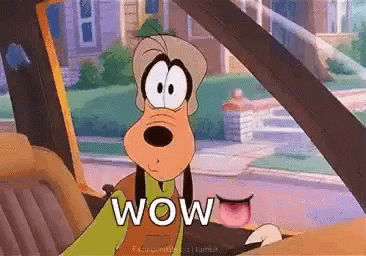 Goofy Is Sitting In The Driver 'S Seat Of A Car . GIF