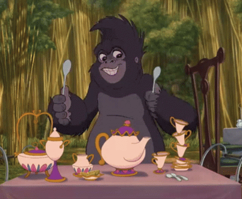 Gorilla Sitting at Table with Teapots and Cups