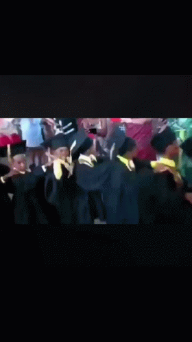 Graduates Dancing in Caps and Gowns