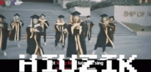 Graduates Dancing in Front of Ship Sign