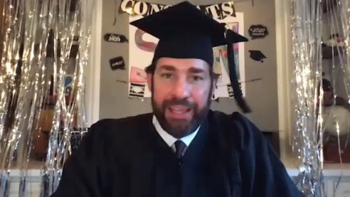 Graduation Man Sitting In Front Of Congrats Sign GIF