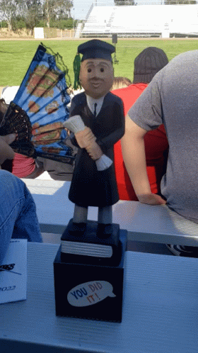 Graduation Statue Holding Diploma