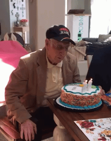 Grandpa Blows Happy 65th Birthday Cake GIF
