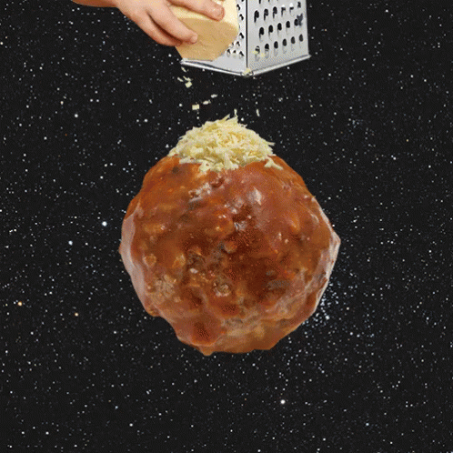 Grating Cheese Over A Meatball GIF