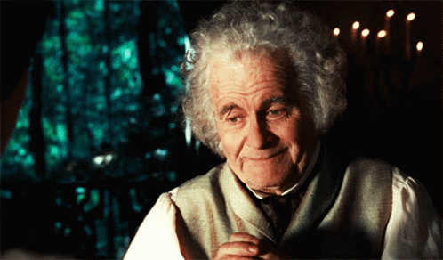 Gray-Haired Man Smiling By Window With Candles GIF