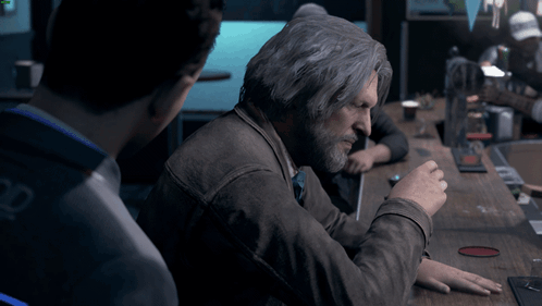 Gray-Haired Man With Beard Sitting at Table