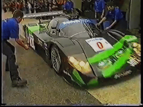 Green and Black Race Car With Number 0