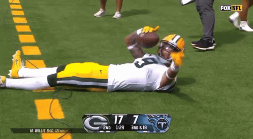 Green Bay Packers Player Laying on Field Score 17 7