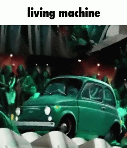 Green Car In Front Of Crowd Saying Living Machine GIF