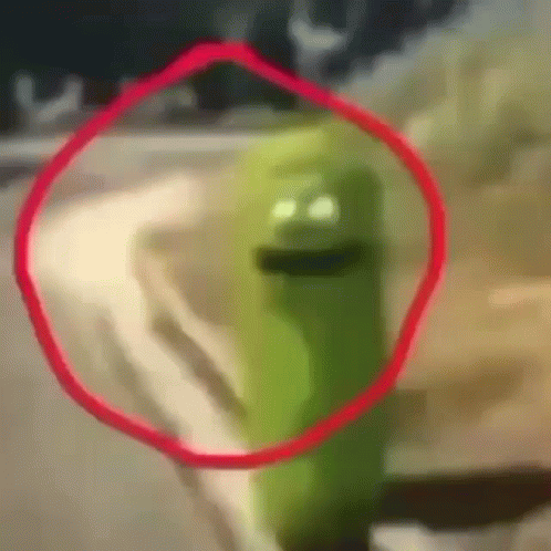 Green Cartoon Character With Red Circle Around Face
