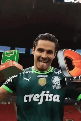 Green Crefisa Jersey Man Holds Up Trophy