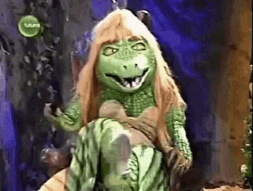 Green Dinosaur Mascot Sitting on Chair