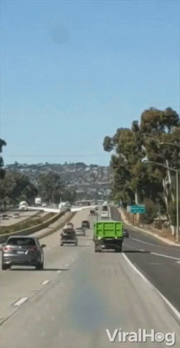 Green Dump Truck on Highway with Viralhog Sign