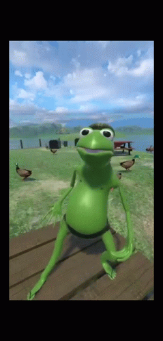 Green Frog Sitting on Wooden Table With Ducks