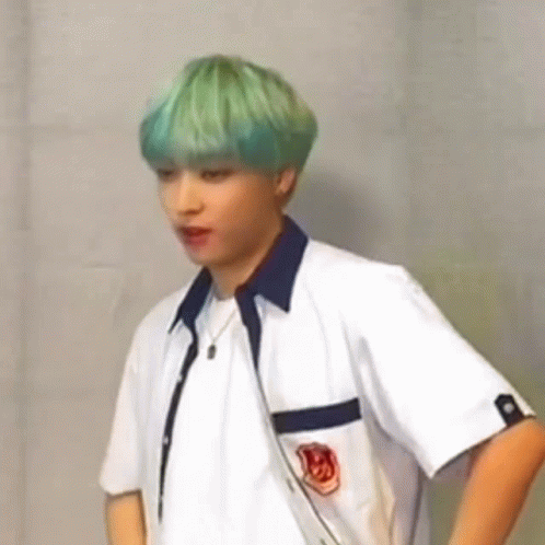 Green-Haired Man White Shirt Hands on Hips