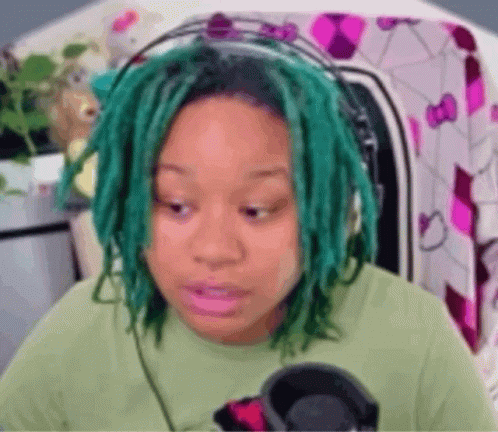 Green-Haired Woman in Green Shirt and Headphones