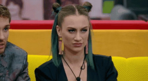Green Haired Woman On Yellow Couch With Man GIF
