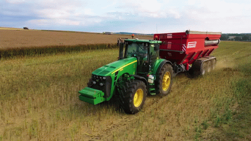 Green John Deere Tractor Pulling Red Bagger