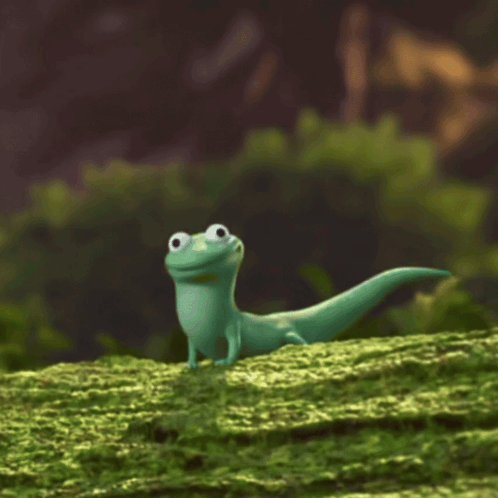 Green Lizard Standing On Mossy Hill GIF