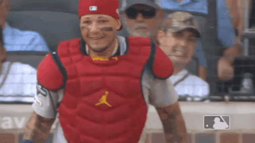 Green Monster Mascot Sitting in Stands