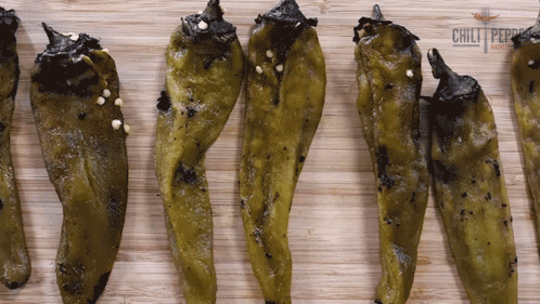 Green Peppers on Wooden Board with Chili Logo