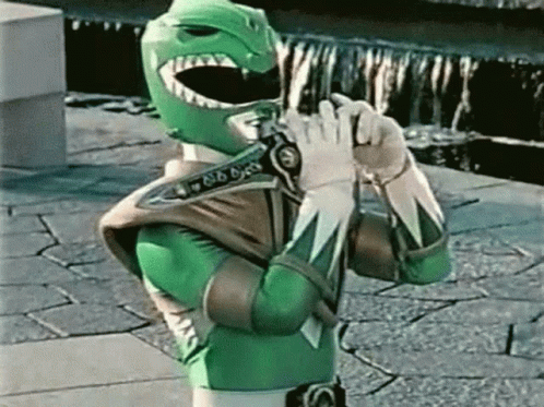 Green Power Ranger Holding Gun on Brick Sidewalk