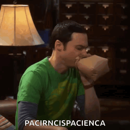 Green Shirt Man Eating Brown Bag Saying pacirncispaciencia