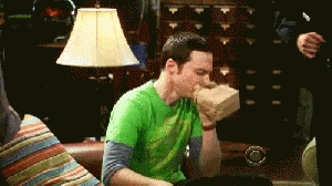 Green Shirt Man Hand in Mouth on Couch
