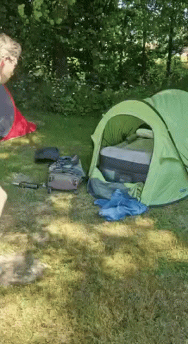 Green Tent in Grass With Suitcase