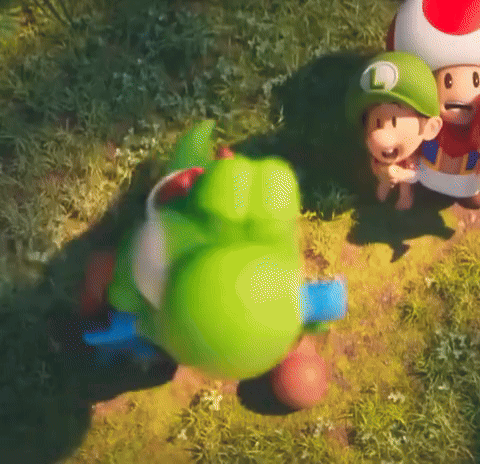 Green Toy With L in Grass