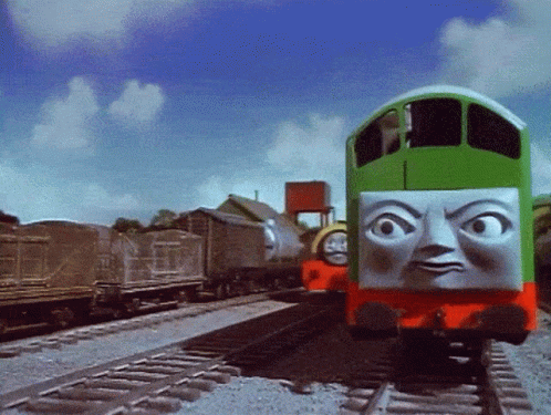 Green Train With Face On Tracks
