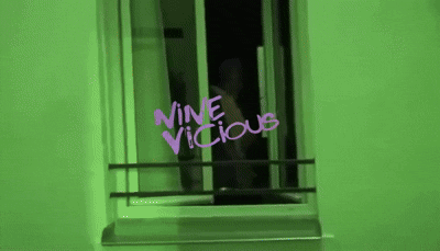 Green Wall With Purple Writing Saying Nine Vicious GIF