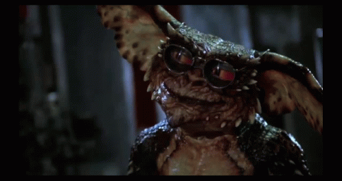 Gremlin Wearing Glasses Looking at Camera